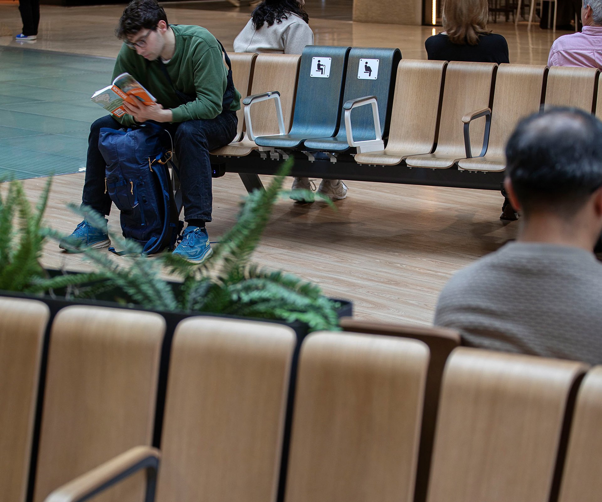 man reading a book on Ascent Back at Madrid airport